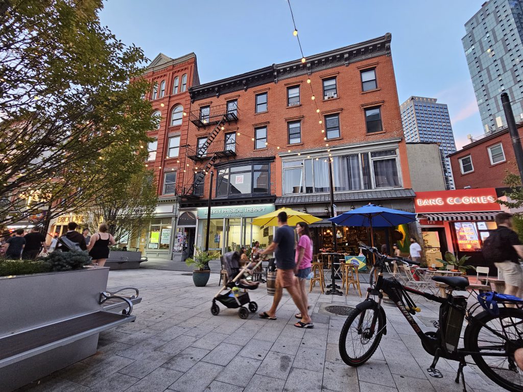 Couple pushing stroller on pedestrian mall in Jersey City
