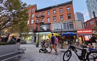 Couple pushing stroller on pedestrian mall in Jersey City