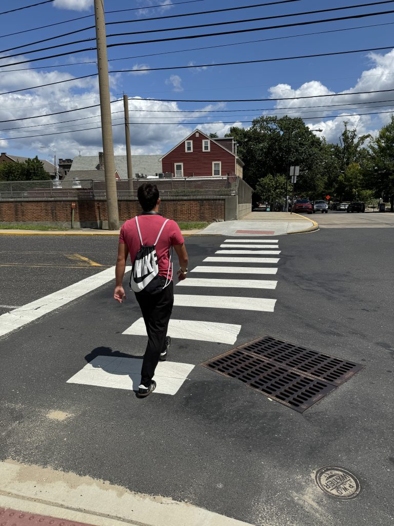 Nils crossing the street in the middle of the crosswalk 4 1